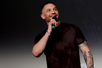 Tom Hardy is seen speaking into a microphone