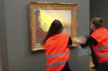 Screenshot from NBC News piece on Climate Activists Throw Mashed Potatoes At Monet Painting.