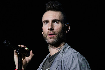 Maroon 5 singer is pictured holding a mic