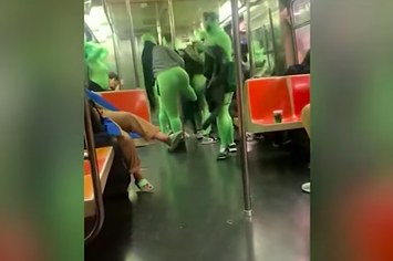 A screenshot from a viral video showing greensuit attackers
