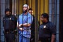 Officials escort "Serial" podcast subject Adnan Syed from the courthouse