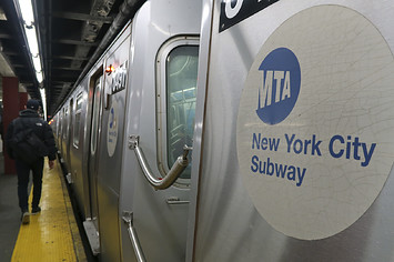 A subway train pulls into a station under Rockefeller Center.