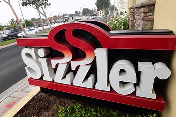 Commuters drive past a closed Sizzler restaurant in Montebello, California