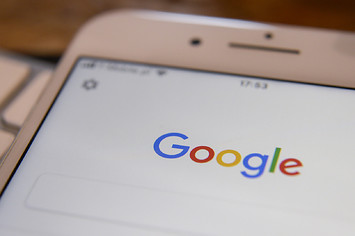 The Google search application is seen running on an iPhone.