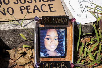 A line of homemade protest signs lay on the steps including one with a picture of Breonna Taylor.