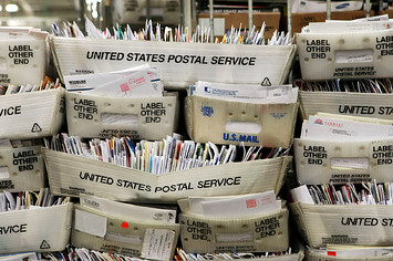 Stacks of boxes holding cards and letters are seen at the U.S. Post Office sort center.