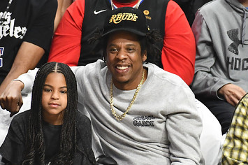 ay Z and Blue Ivy Carter attend a basketball game