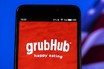 In this photo illustration, the GrubHub logo seen displayed on a smartphone.