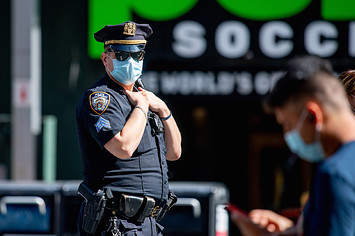An NYPD police officer wears a mask in Times Square
