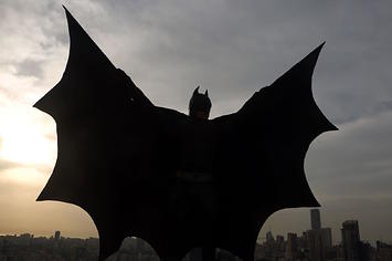 Lebanese model dressed as Batman on rooftop of building during a photoshoot in Beirut.