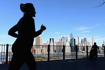 A woman jogs along the Brooklyn Heights promenade.