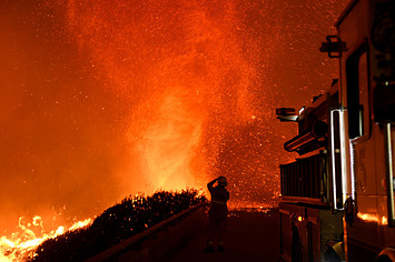 California firefighter watching fire tornado.