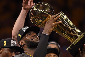 Cleveland Cavaliers' LeBron James (23) holds up the Larry O'Brien trophy
