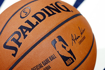 A detail view of official Spalding NBA logo basketball on the floor.