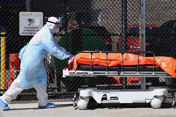 Medical staff move bodies from the Wyckoff Heights Medical Center to a refrigerated truck.