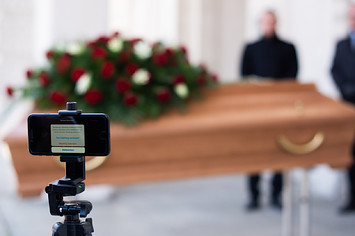 Employees of Bestattung Himmelblau undertakers rehearse livestream of upcoming funeral.