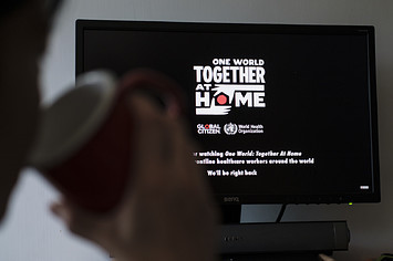 A person watches live streaming of One World Together At Home