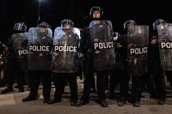 Detroit Police officers watch demonstrators in the city of Detroit, Michigan