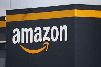 The logo of Amazon is seen on the facade of the company logistics center.