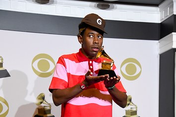 Tyler the Creator poses in the press room with the award for Best Rap Album