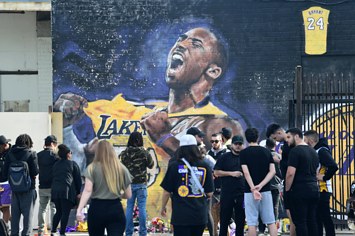 Fans surround a Kobe Bryant mural in the hours after his death.