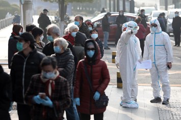 People line up to get nuclei testing for SARS COV 2 at a hospital in Wuhan.