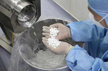 Employee checks the production of chloroquine phosphate in a pharmaceutical company.