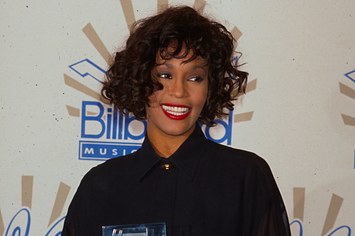 Singer Whitney Houston holding her award in Press Room at Billboard Music Awards