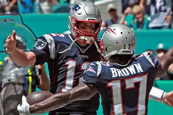 Tom Brady and Antonio Brown embrace after a touchdown.
