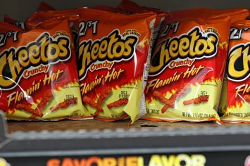 Bags of Flamin' Hot Cheetos sit on store shelves.