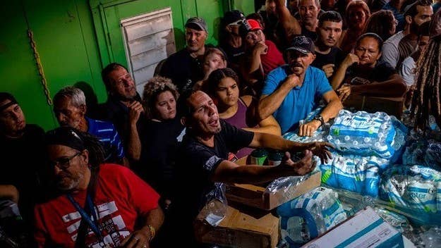 Footage shows residents opening the warehouse doors to reveal pallets of supplies believed to originate from Maria relief efforts.