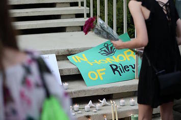 Students honor the victims of a shooting at the University of North Carolina Charlotte.