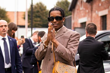 ASAP Rocky, wearing brown blazer, blue jeans, Gucci bag and Gucci shoes