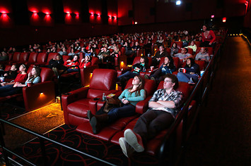 People relax in all powered recliner seats at AMC Movie Theater.