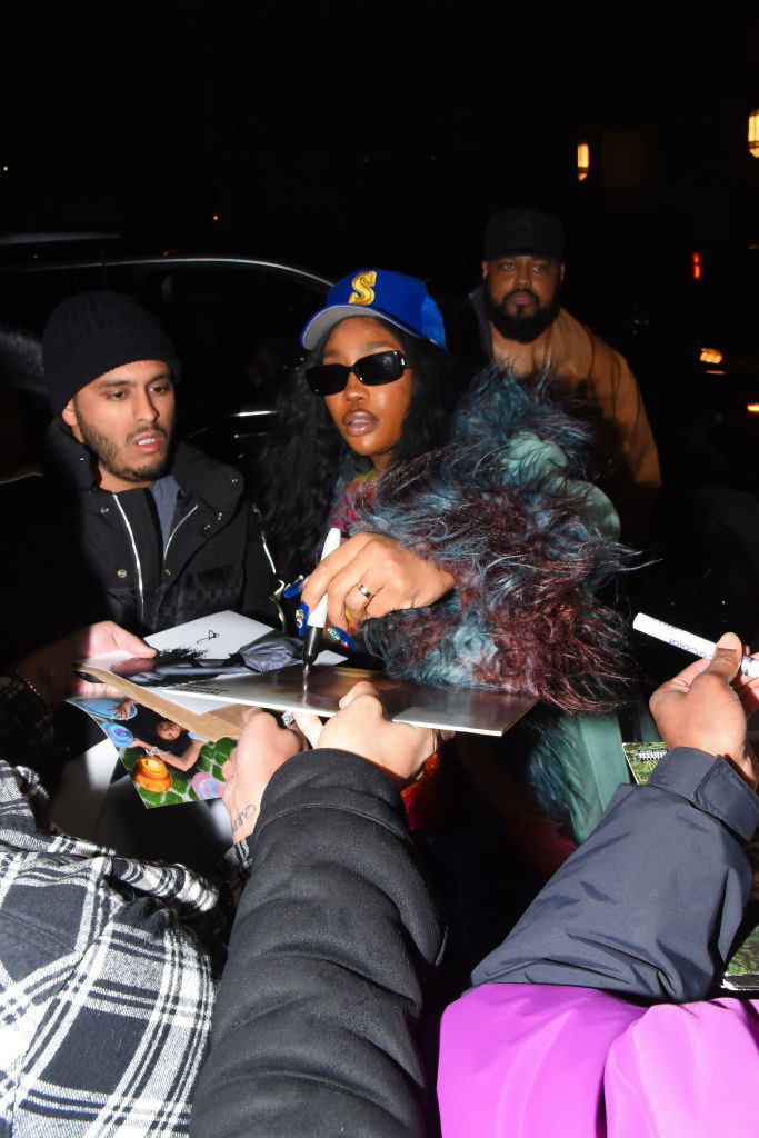 SZA signing autographs