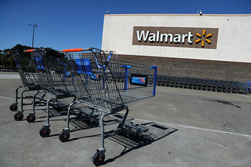 Shopping carts sit in front of a Walmart store