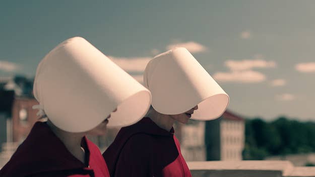 One couple is catching a ton of flak for their decision to theme their wedding photo around 'The Handmaid's Tale.'
