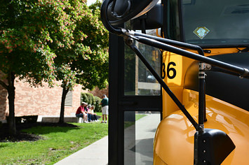 School Bus Close up and Waiting Bus Drivers