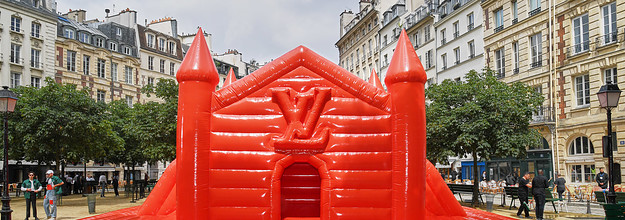 A red bouncy castle in the middle of a beautiful square in Paris