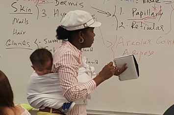 Professor Ramata Sissoko Cissé holds baby during lecture.
