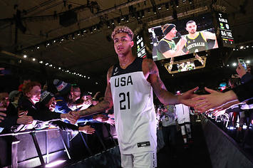 Kyle Kuzma high fives fans of Team USA during an exhibition against Australia.