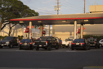 Continuous lines of vehicles find gasoline at the Texaco station.