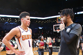 Devin Booker #1 of the Phoenix Suns talks with D'Angelo Russell