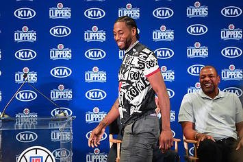 Kawhi Leonard walks past coach Doc Rivers during his Clippers introduction.