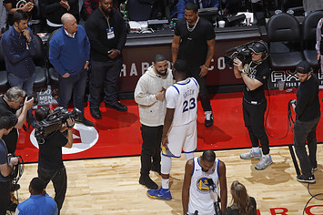 Draymond Green and Drake talk after the game.