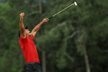 Tiger Woods of the United States celebrates after sinking his putt on the 18th green