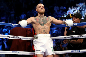 Conor McGregor stands in his corner during his super welterweight boxing match