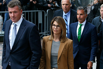Lori Loughlin leaves as her husband Mossimo Giannulli, in green tie at right, follows