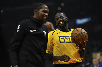 Kevin Durant talks to his teamate Draymond Green during warm up.