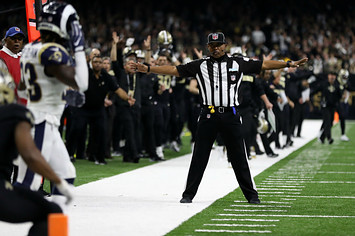 A referee watches as Tommylee Lewis #11 of the New Orleans Saints drops a pass